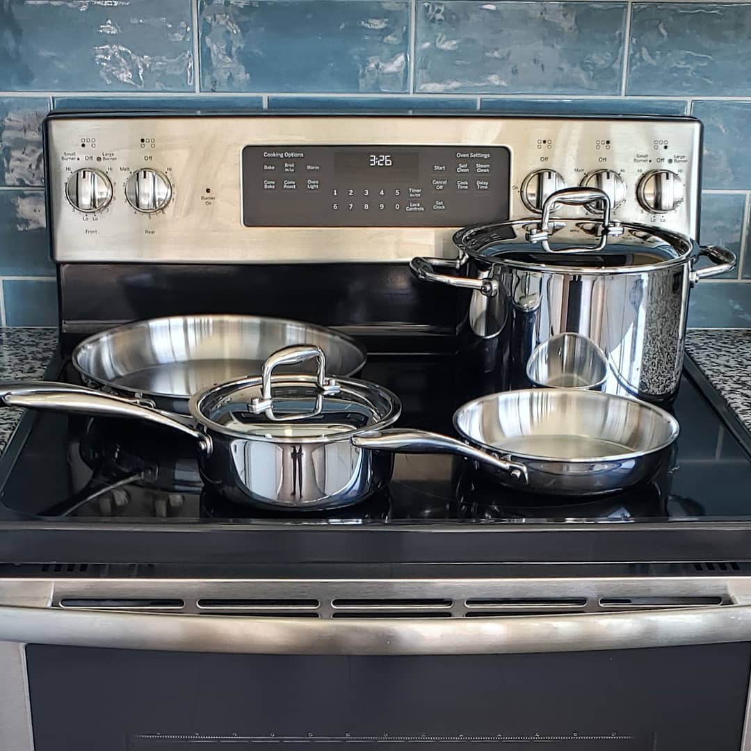 Product photo, 4 Brandless cookware items on an electric stovetop in a kitchen.
